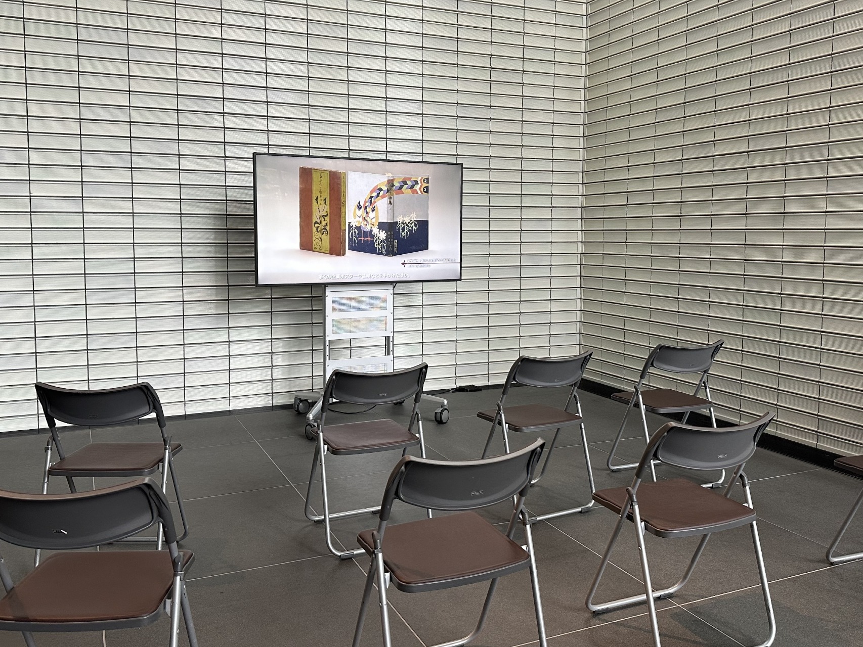 모니터 앞에 파이프 의자가 놓여 있습니다.