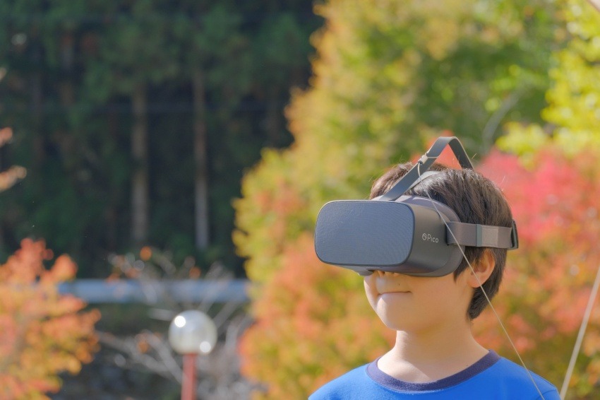 Photo of a boy experiencing VR goggles